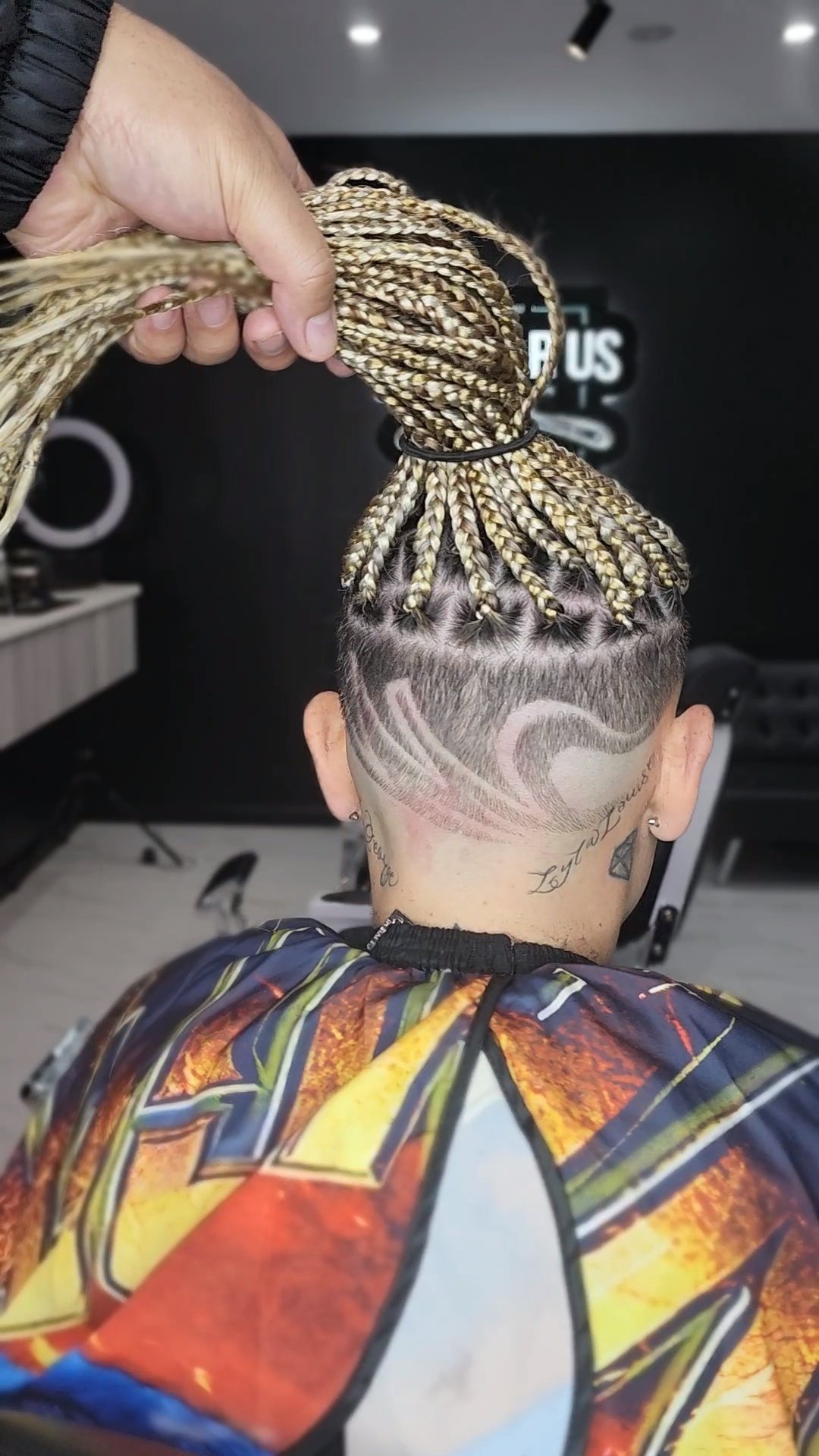 Barber finishing a client's fade